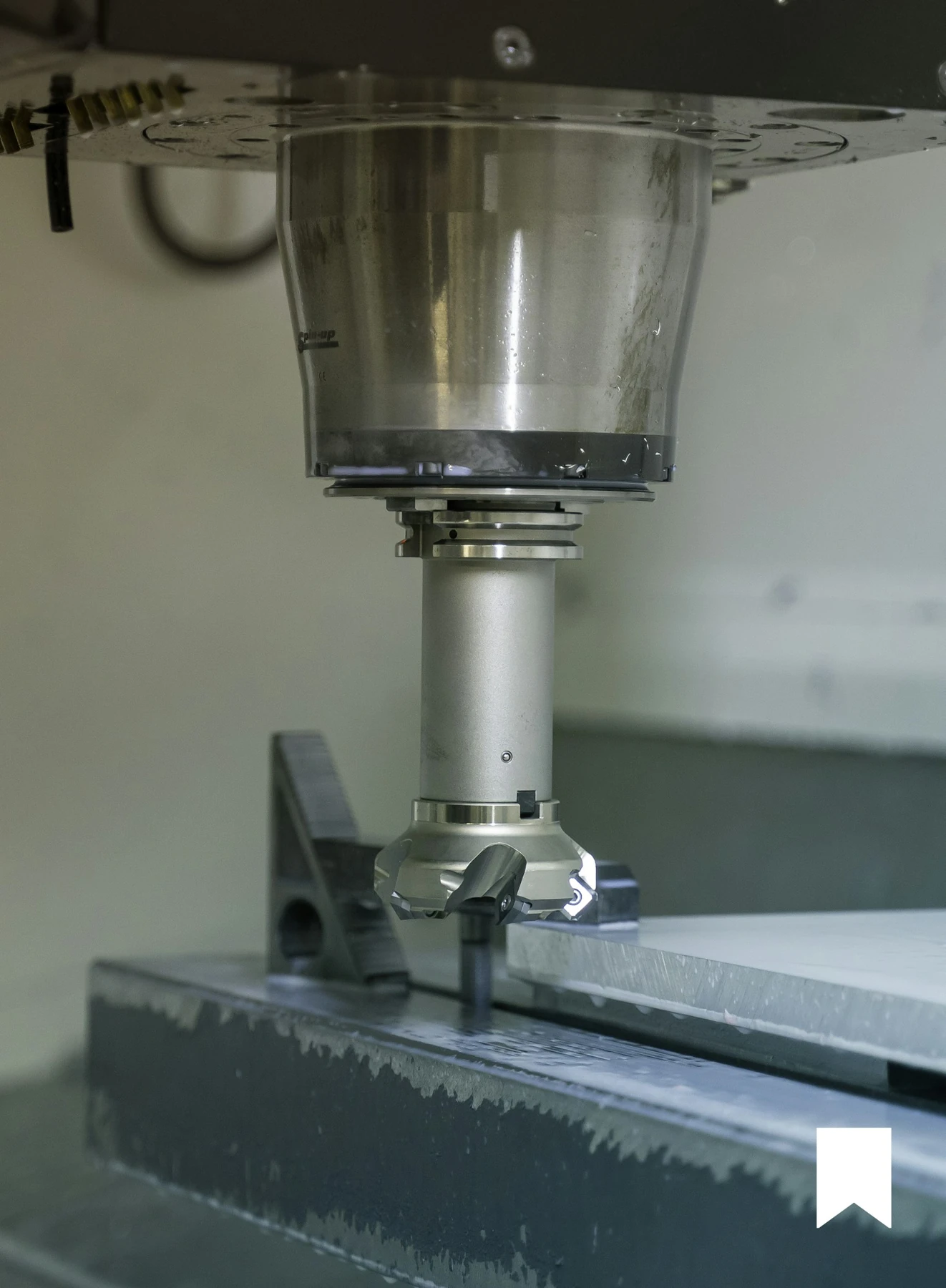 Indexable tungsten carbide inserts milling a steel workpiece