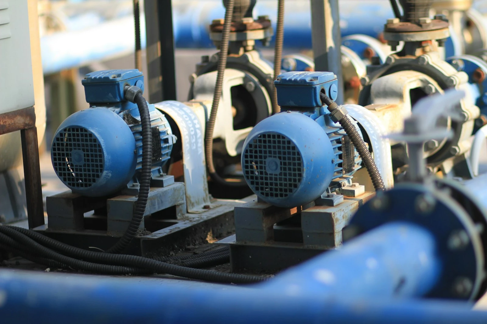 Industrial centrifugal pump units with motors and connected process pipework